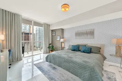 a bedroom with a large bed and a large window at Luxurious 5-STAR condo at the ICON Brickell in Miami