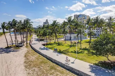 an aerial view of a park with palm trees and a sidewalk at SeaStays- South Beach Apartments in Miami Beach