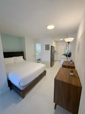 a bedroom with a bed and a table in it at SeaStays- South Beach Apartments in Miami Beach