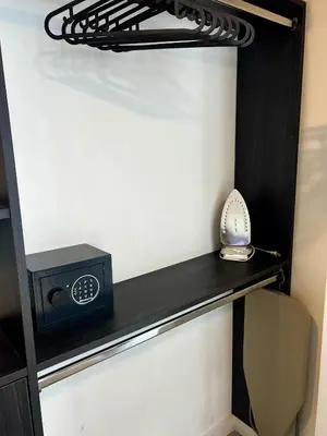 a black shelf with a alarm clock on it in a room at The Art Studio Downtown in Miami