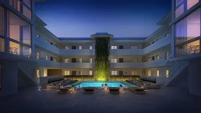 a large building with a water fountain in the middle at Beach Haus Key Biscayne Contemporary Apartments in Miami