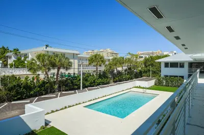a view of a swimming pool from the balcony of a house at Beach Haus Key Biscayne Contemporary Apartments in Miami