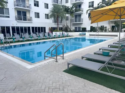 a swimming pool with lounge chairs and a hotel at The Art House Little Havana in Miami