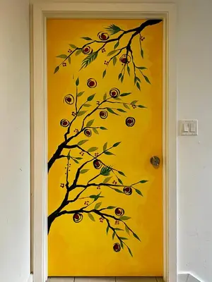 a painting of a tree on a yellow door at The Art House Little Havana in Miami
