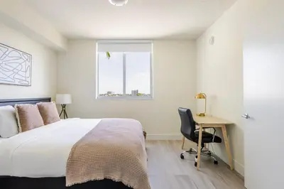 a bedroom with a bed and a desk and a window at Blueground Riverside pool AC nr parks MIA-144 in Miami
