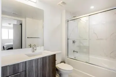 a bathroom with a toilet and a sink and a shower at Blueground Riverside pool AC nr parks MIA-144 in Miami