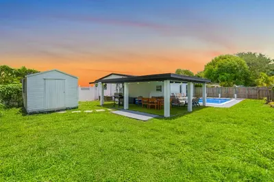a gazebo and a house in a yard at Private Pool Home & Arcade game & Mini Basketball in Hollywood