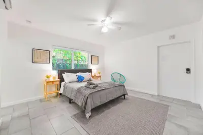 a bedroom with a bed and a ceiling fan at Charming Miami Studio in Prime Location in Miami