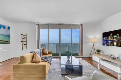 a living room with a couch and a large window at City-View Retreat in Brickell 2BR and Free Parking in Miami