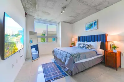 a bedroom with a bed and a large window at Stylish Midtown Miami Condo - Pool & Prime Location in Miami