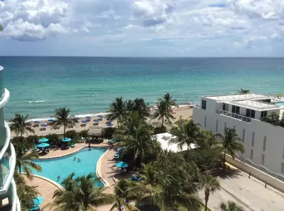 an aerial view of a resort with a swimming pool and the ocean at Komffy Apartment with 2 King Beds OceanView at Tides in Hollywood