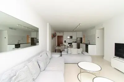 a white living room with a white couch and tables at Komffy Apartment with 2 King Beds OceanView at Tides in Hollywood