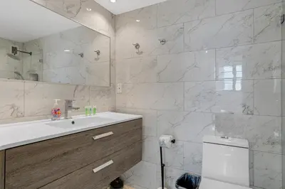 a white bathroom with a sink and a toilet at Komffy Apartment with 2 King Beds OceanView at Tides in Hollywood