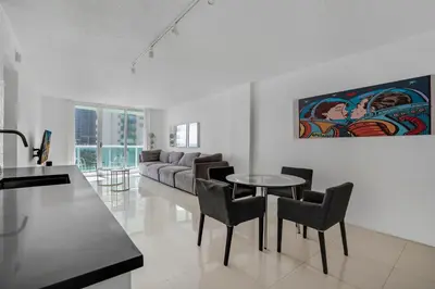 a living room with a table and chairs and a couch at Komffy Apartment with 2 King Beds OceanView at Tides in Hollywood