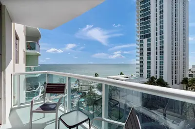 a balcony with chairs and a view of the ocean at Komffy Apartment with 2 King Beds OceanView at Tides in Hollywood