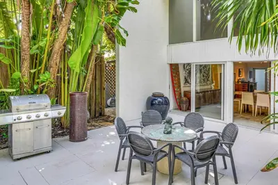 a patio with a table and chairs and a kitchen at Wonderful Tropical Pool House Miami Coconut Grove in Miami