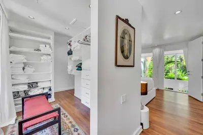 a walk in closet with a red chair at Wonderful Tropical Pool House Miami Coconut Grove in Miami