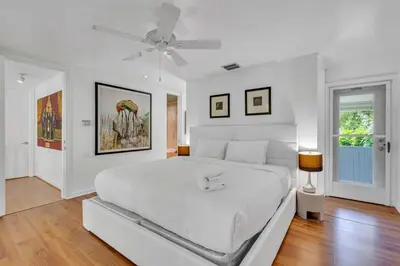 a white bedroom with a bed and a ceiling fan at Wonderful Tropical Pool House Miami Coconut Grove in Miami