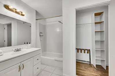 a white bathroom with a sink and a shower at Inn On The Drive in Fort Lauderdale