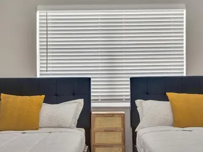 a bedroom with two beds and a large window at Beachside 1BR in Hollywood | Parking + WiFi in Dania Beach