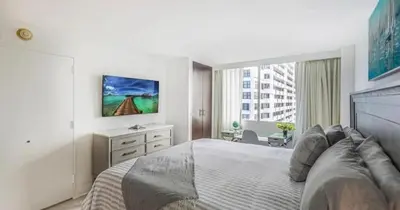 a bedroom with a large bed and a window at Modern Condo by the Beach, Water Taxi Stop, Prime Location! in Fort Lauderdale