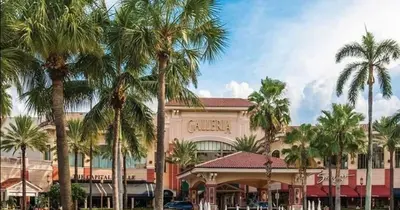 a large building with palm trees in front of it at Modern Condo by the Beach, Water Taxi Stop, Prime Location! in Fort Lauderdale