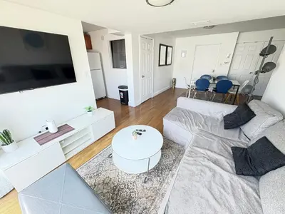 a living room with a couch and a flat screen tv at South Beach and Collins, Parking included in Miami Beach