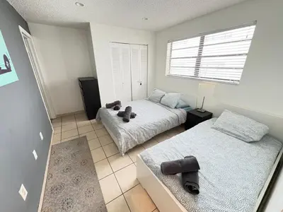 a bedroom with two beds and a window at South Beach and Collins, Parking included in Miami Beach