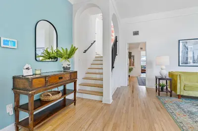 a living room with blue walls and a table and stairs at Havana Oh Na Na Unit A in Miami