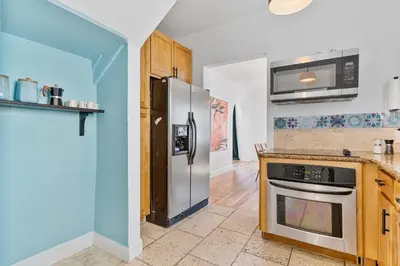 a kitchen with a stainless steel refrigerator and a stove at Havana Oh Na Na Unit A in Miami