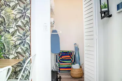 a hallway with a white door with a bunch of clothes at Havana Oh Na Na Unit C in Miami
