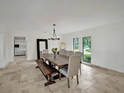 a dining room with a wooden table and chairs at Villa Riverland in Fort Lauderdale