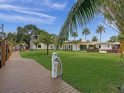 a camera on a boardwalk next to a yard at Villa Riverland in Fort Lauderdale