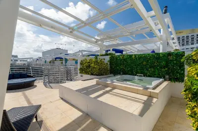 a hot tub on the roof of a building at Penthouse with Private Rooftop in Miami Beach