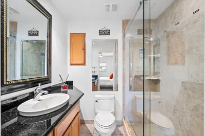a bathroom with a toilet and a sink and a shower at Waterfront Oasis with Pool, Sunset Views and Dock in Fort Lauderdale