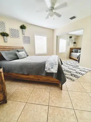 a bedroom with a bed and a ceiling fan at Fort Lauderdale Florida Beach Vibe Hangout in Fort Lauderdale
