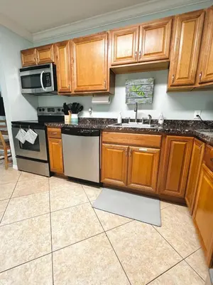a kitchen with wooden cabinets and a sink at Fort Lauderdale Florida Beach Vibe Hangout in Fort Lauderdale