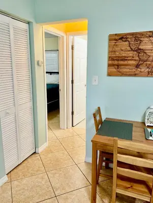 a dining room with a table and a bedroom at Fort Lauderdale Florida Beach Vibe Hangout in Fort Lauderdale