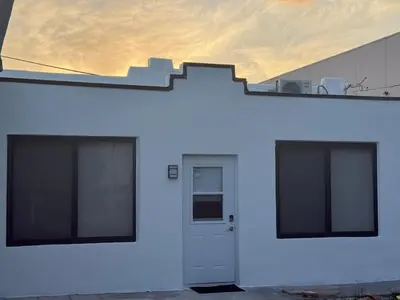 a white building with a staircase on the side of it at Modern and private studio in Miami