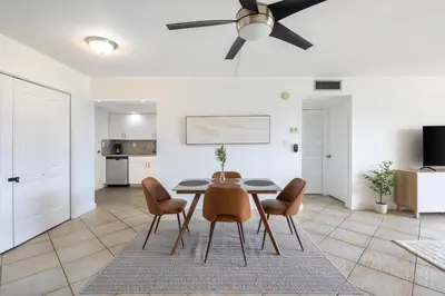 a living room with a dining room table and chairs at Tiny Tower Treasure - Sleeps 5 & Soaks Sun in Sunny Isles Beach