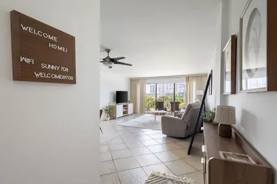 a living room with a couch and a table at Tiny Tower Treasure - Sleeps 5 & Soaks Sun in Sunny Isles Beach