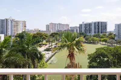 a view of a park with palm trees and buildings at Tiny Tower Treasure - Sleeps 5 & Soaks Sun in Sunny Isles Beach