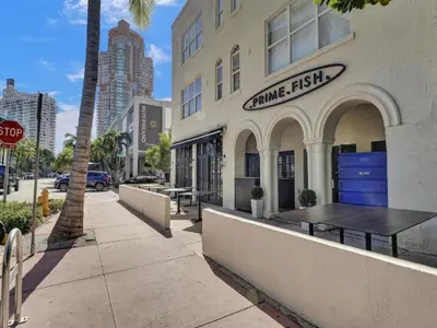 a coffee shop on a street with a stop sign at Pool and Jacuzzi. Walk to beach, South Point Pier in Miami Beach
