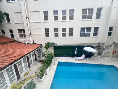a swimming pool in front of a building at Pool and Jacuzzi. Walk to beach, South Point Pier in Miami Beach