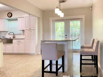 a kitchen with a table and chairs in a room at 2 Bedroom Cozy House Near Barry University in Miami