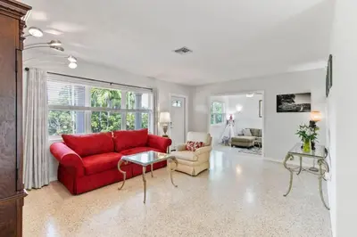 a living room with a red couch and a table at 2 Bedroom Cozy House Near Barry University in Miami