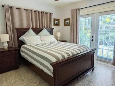 a bedroom with a large bed and a window at 2 Bedroom Cozy House Near Barry University in Miami