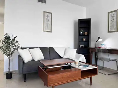 a living room with a couch and a table at Right on the beach, Ocean Drive Secured Condo in Miami Beach