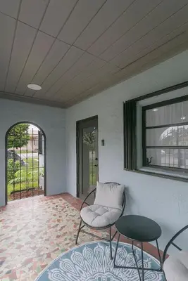 a room with a chair and a table and a window at Center Miami Designer Home 3 BR sleeps 9 in Miami