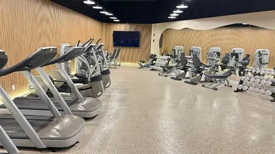 a gym with rows of exercise bikes and treadmills at Shine Suites Balcony Duplex 5 in Miami Beach
